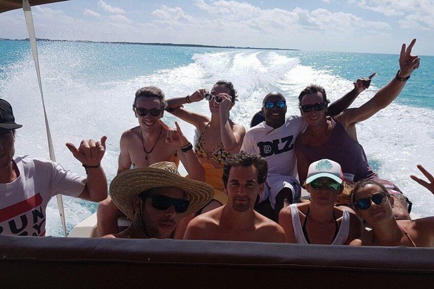 A group of people on a boat with the ocean in the background. 2