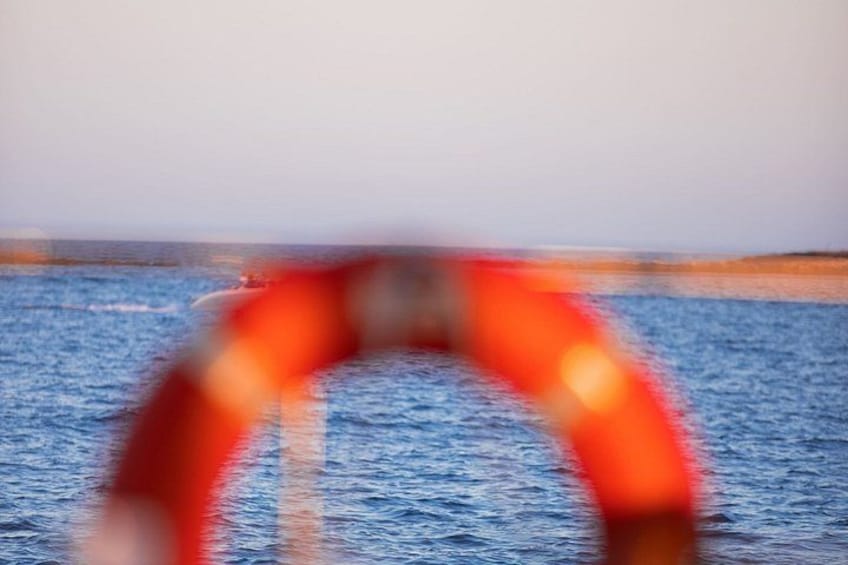 A blurred view of a body of water with a red object in motion. 2