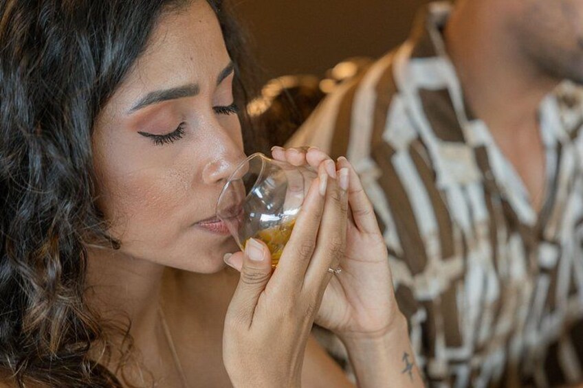 A person holding a glass with a beverage. 3