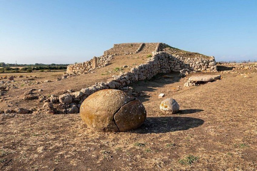 Ancient ruins with stone structures and large boulders. 1