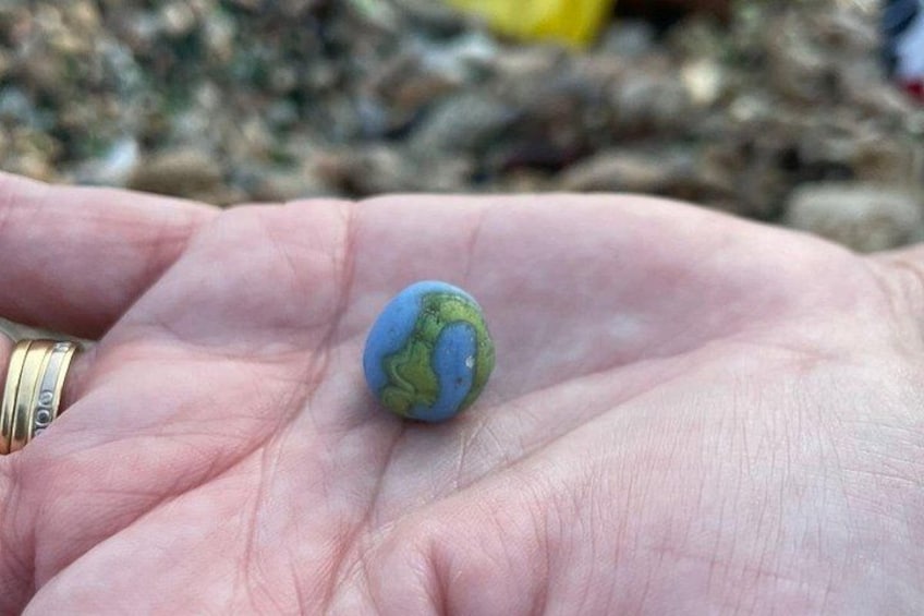 A hand holding a small globe. 4