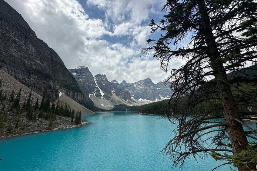 A turquoise lake surrounded by mountains and coniferous trees. 3