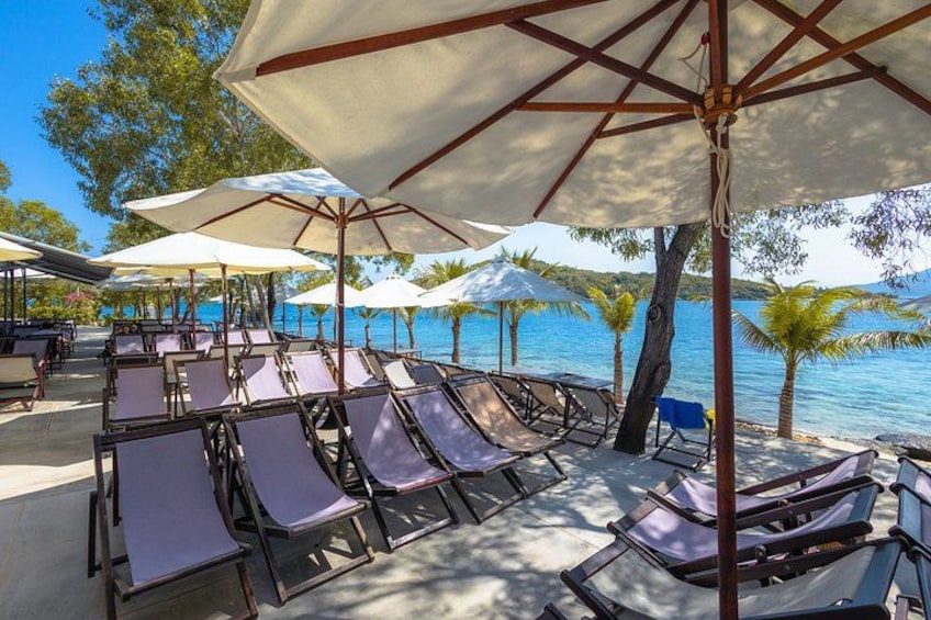 A beachside lounge area with sun loungers and umbrellas. 4