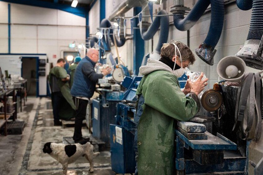 A workshop with machinery and a dog on the floor. 1