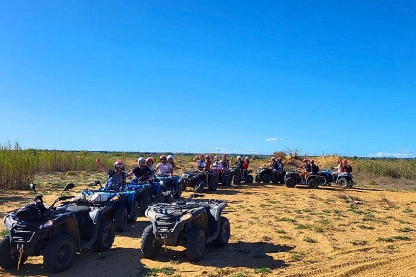 A group of people on quad bikes in a desert landscape. 2