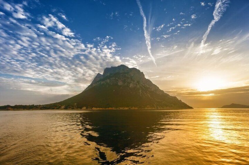 A mountain reflected in calm water with a sunset. 3