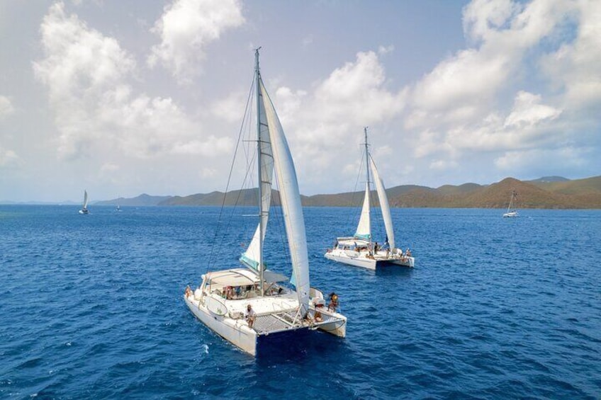 Two sailboats on a calm sea with distant land in the background. 5