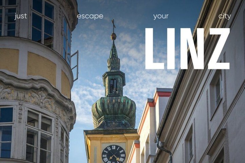 A clock tower with a spire, surrounded by historic buildings. 3