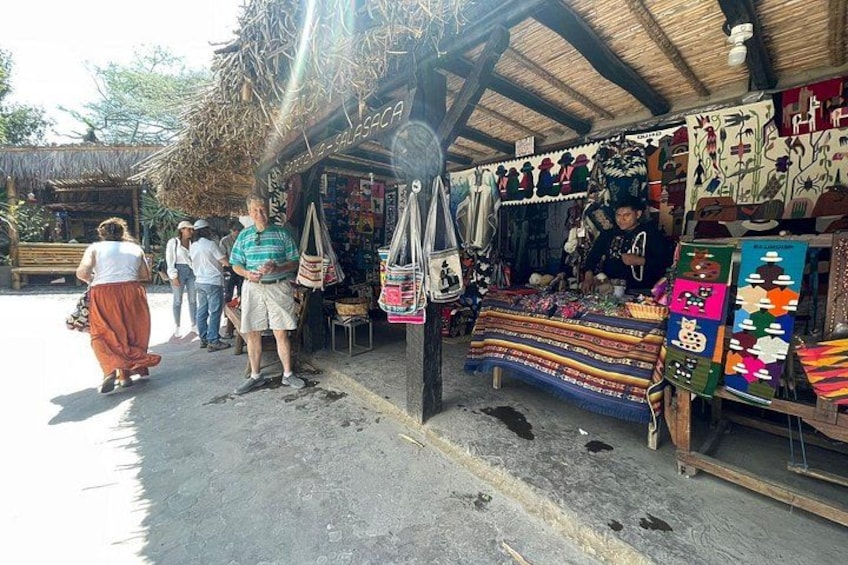 A market stall with colorful textiles and a person standing behind it. 4