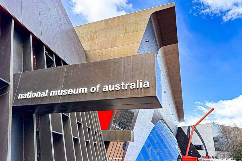 The exterior of the National Museum of Australia with a prominent sign. 2