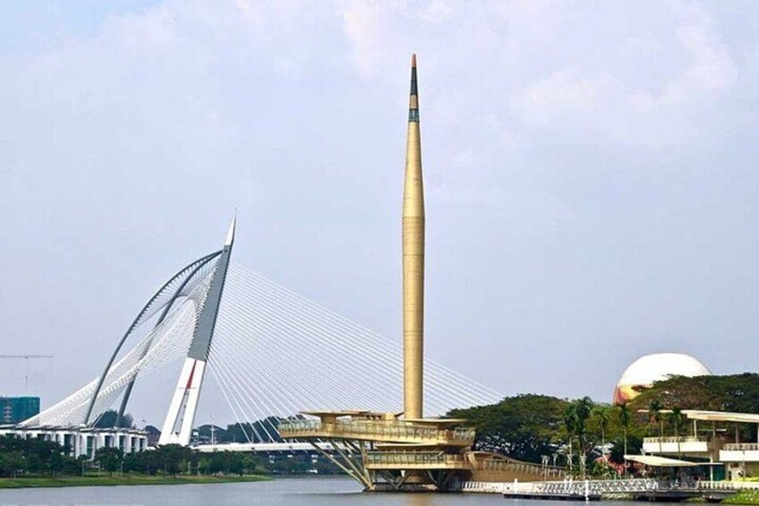 A tall monument with a pointed tip, a modern bridge with cables, and a large spherical structure in the background. 4
