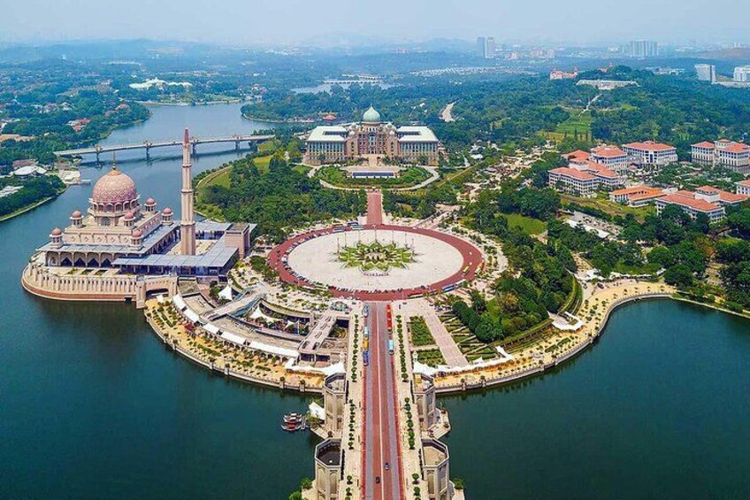An aerial view of a city with a large circular park, a mosque with a dome, and a river. 2