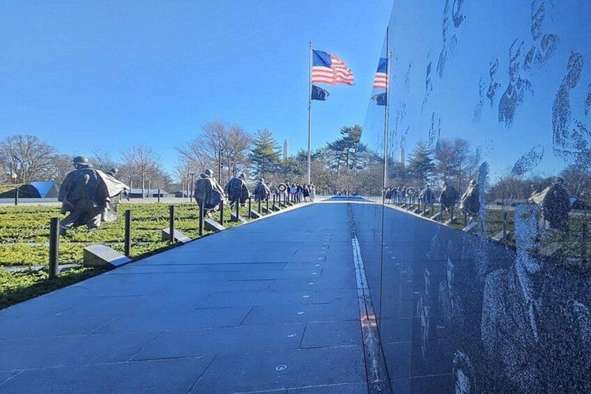 A pathway with statues and American flags. 5
