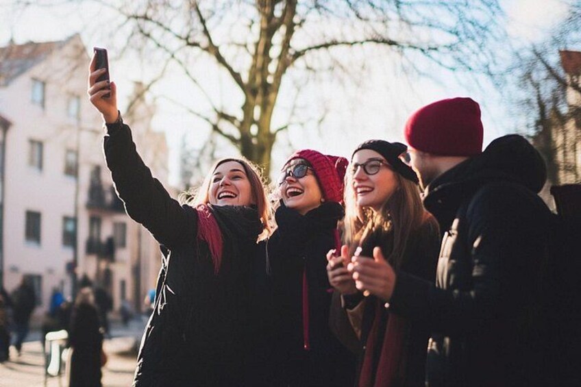 A group of people taking a selfie outdoors. 2