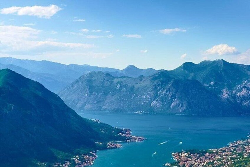 A mountainous landscape with a lake and a town. 5