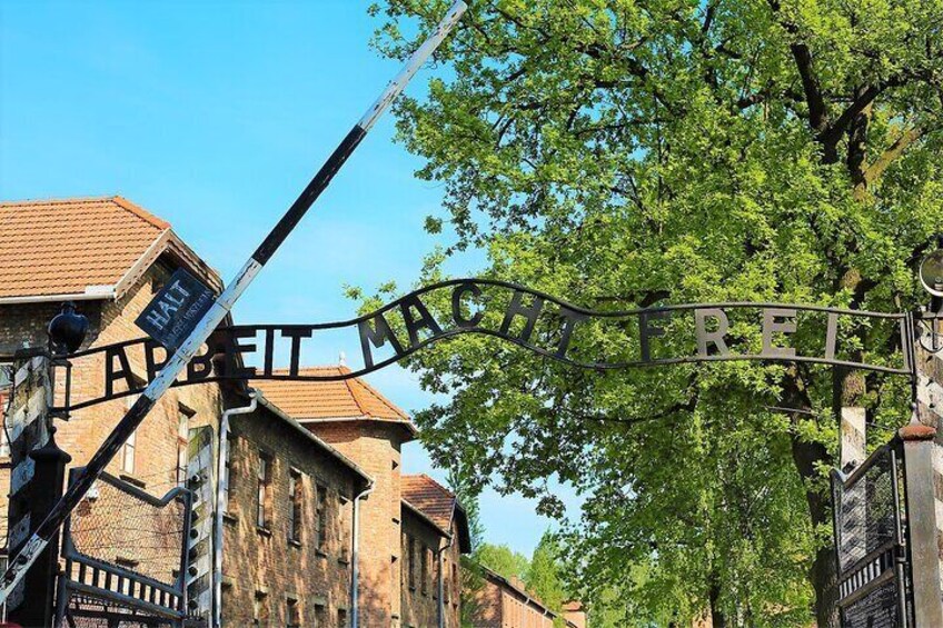 A metal sign with 'HART' and 'MACH' inscribed, with a tree in the background. 1