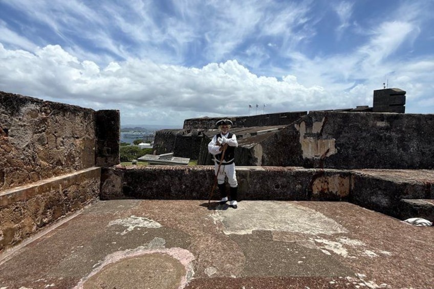 A historical site with old stone walls and a person in period clothing. 3