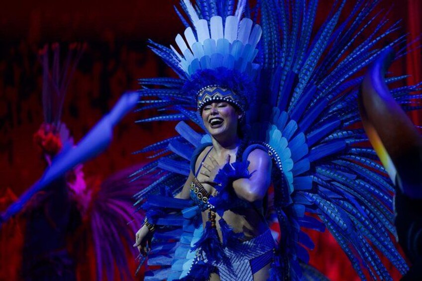 A person in a blue costume with a large headdress. 3
