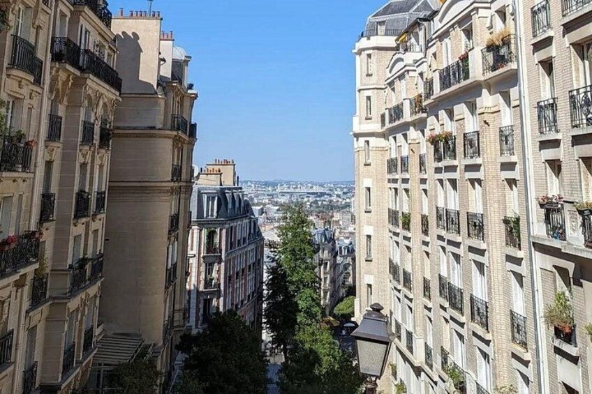 A cityscape with tall buildings, a clear sky, and a distant view of a city. 1