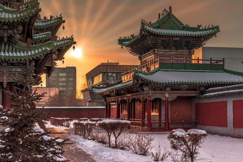 A traditional Chinese building with ornate architecture, a snow-covered pathway, and a sunset in the background. 3