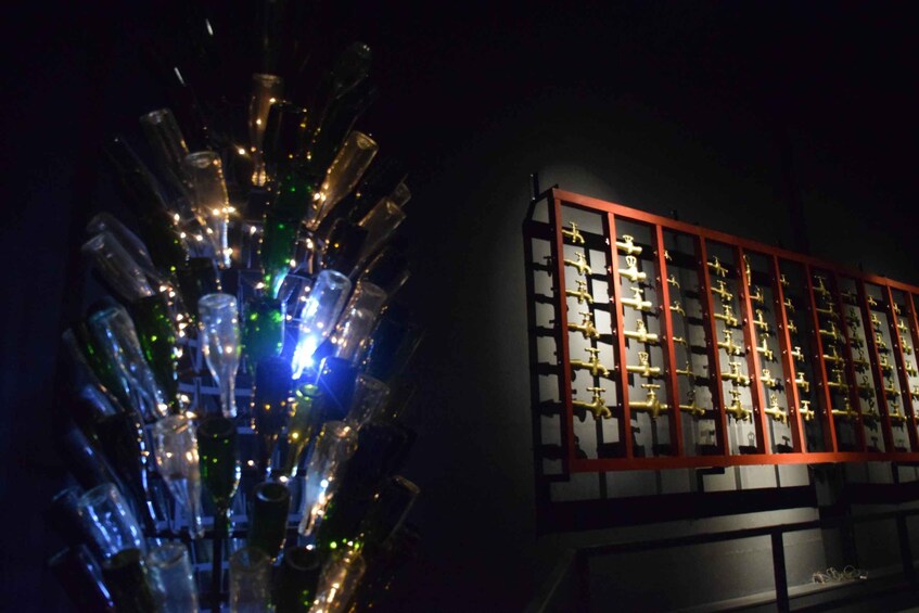 A collection of glass bottles and a display of antique faucets. 4
