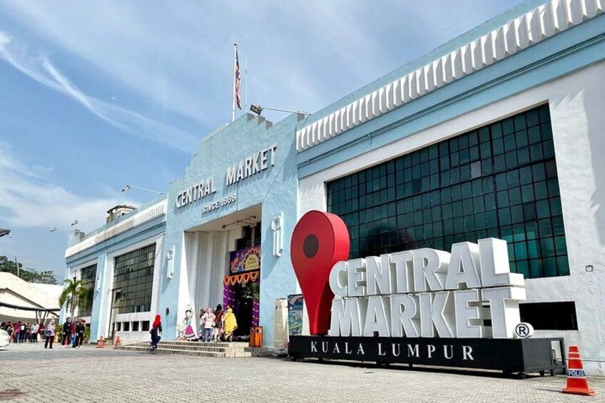 The Central Market building with a large red location pin and the text 'Central Market Kuala Lumpur' on the facade. 3