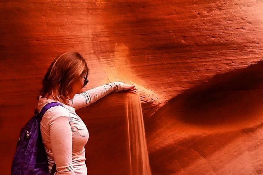 A person leaning against a canyon wall. 3