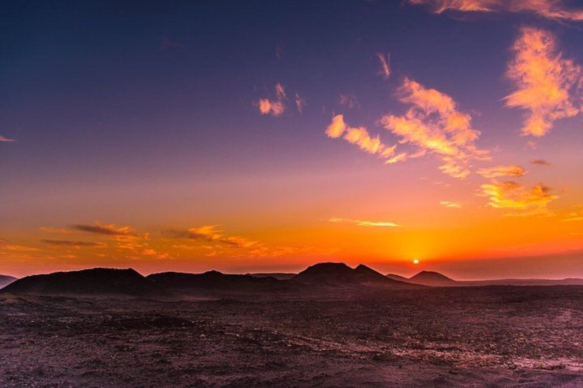 A sunset over a mountainous landscape with a clear sky. 3
