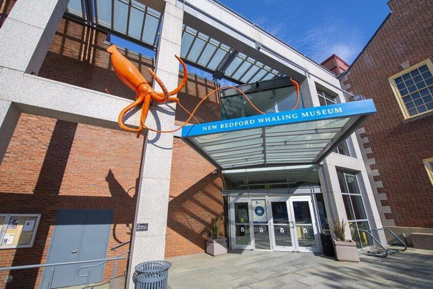 The New Bedford Whaling Museum entrance with a large whale sculpture. 1