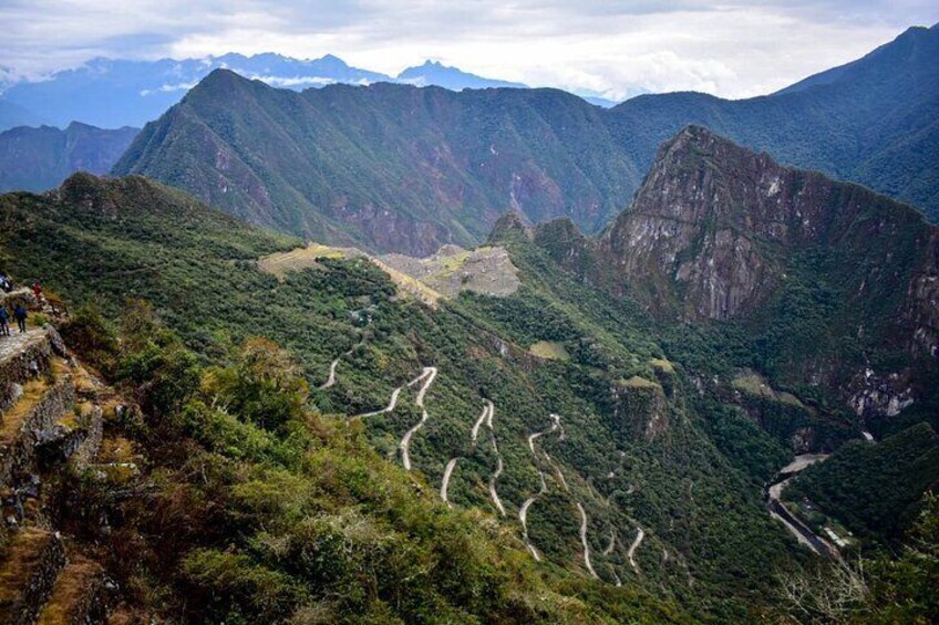 A mountainous landscape with winding roads and lush greenery. 3