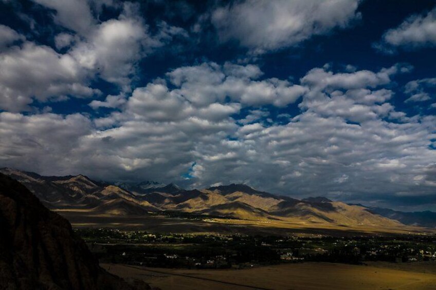 A mountainous landscape with a town in the valley. 2