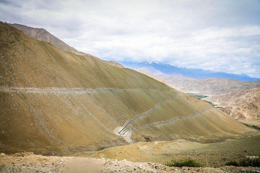 A mountainous landscape with a winding road. 4
