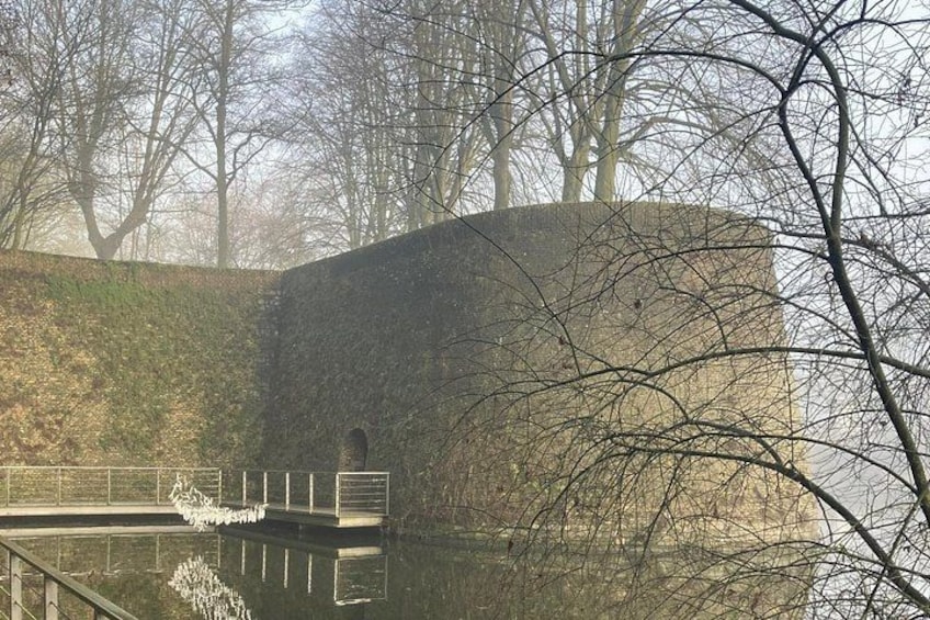 A stone wall, a bridge, and a body of water. 2