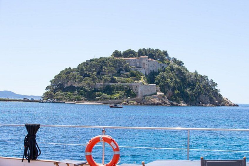 A coastal scene with a small island, a lifebuoy, and a boat. 3