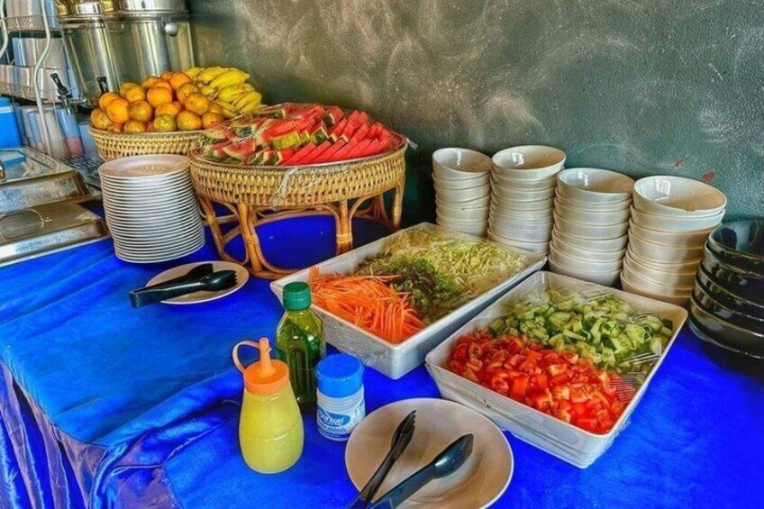A buffet table with various food items and serving utensils. 5