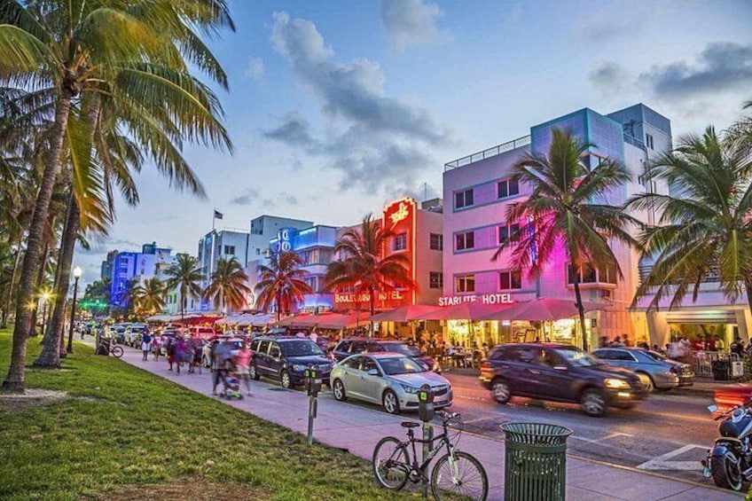 A busy street with palm trees, cars, and a hotel named 'Starff Hotel'. 3