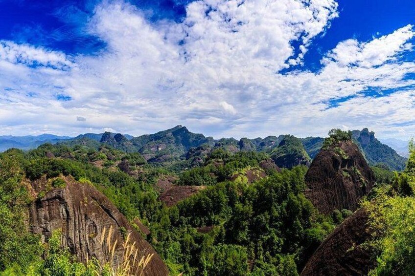 A mountainous landscape with dense vegetation and rocky outcrops. 2