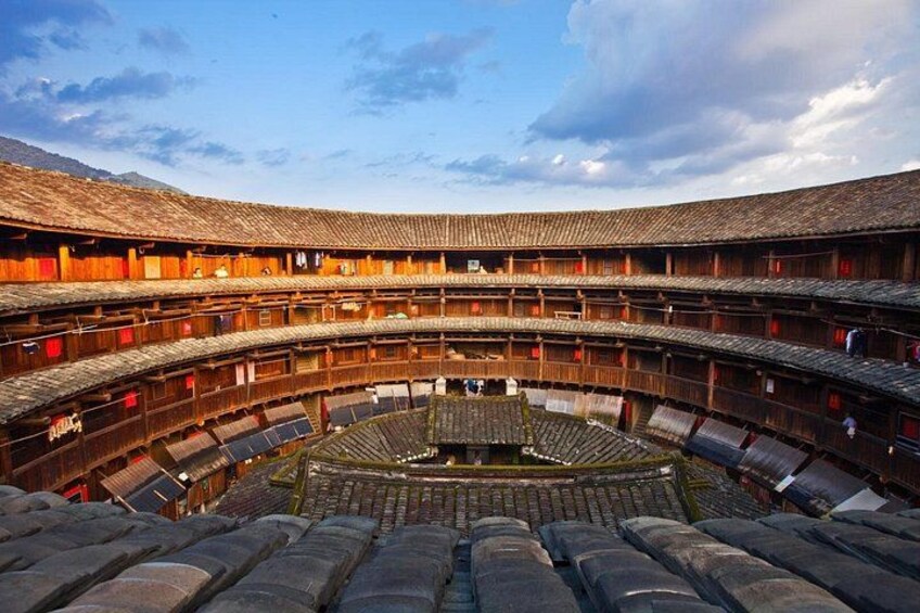 A traditional wooden amphitheater with tiered seating and a central stage. 3