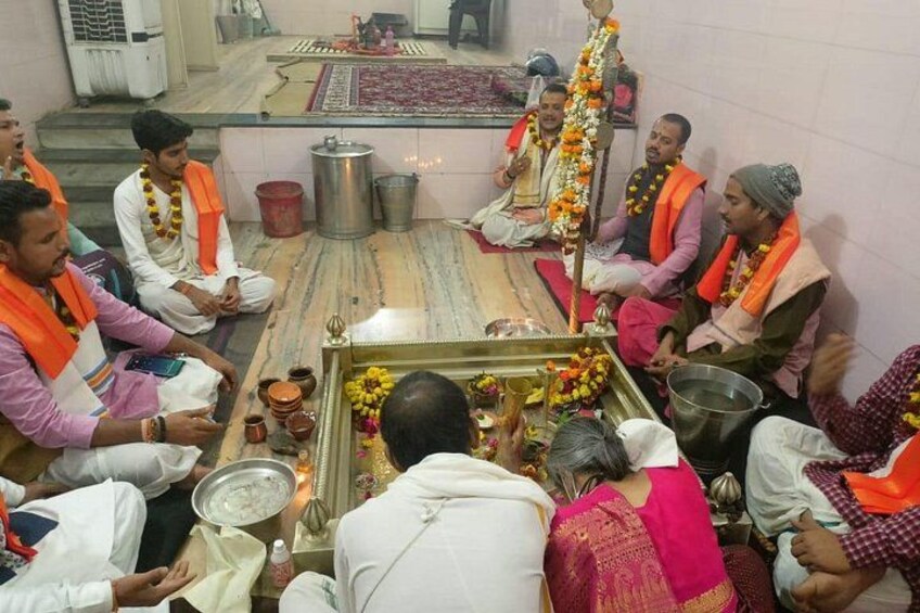 A group of people sitting in a circle around a ceremonial altar with offerings. 4