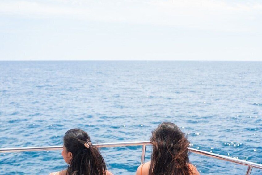 Two people on a boat with the ocean in the background. 5