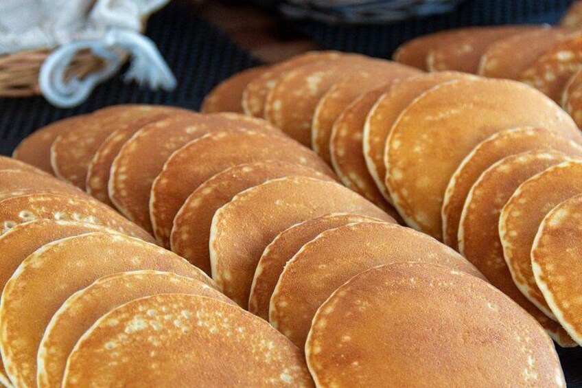 A stack of golden-brown pancakes. 4