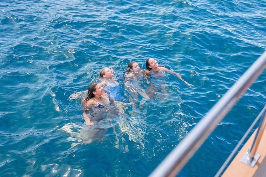 People swimming in a body of water. 5