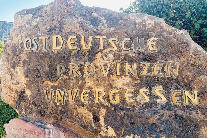 A large rock with carved text reading 'OSTDEUTSCHE PROVINZEN UNVERGESEN'. 3
