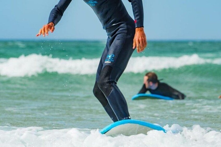 A person surfing on a wave with a blue surfboard. 3