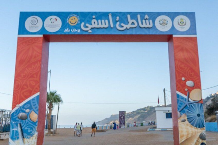 A beach entrance archway with decorative elements and a clear sky. 2