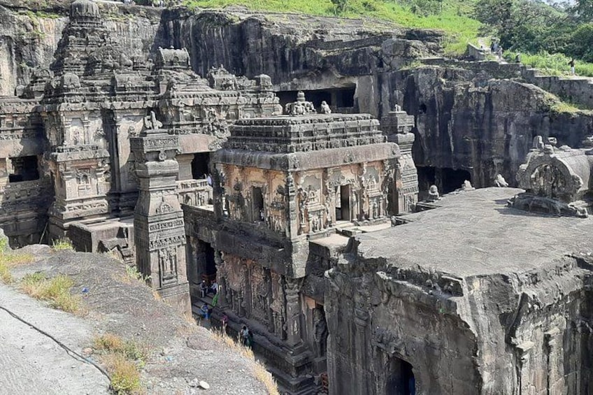 Ancient rock-cut architecture with intricate carvings and a large open space. 4