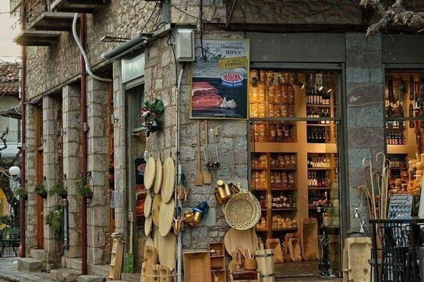 A stone building with a shop window displaying various items. 2