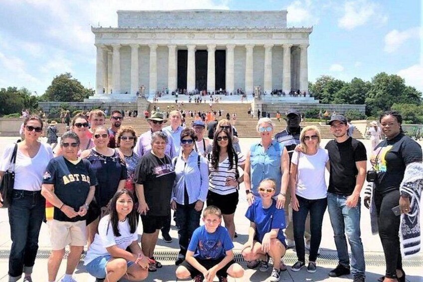 A group of people posing in front of the Lincoln Memorial. 4