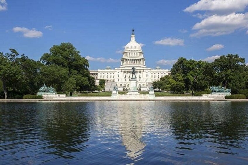 The United States Capitol building with a reflecting pool in front. 2