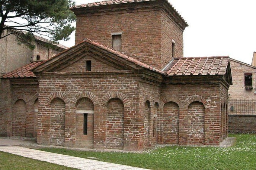 A brick building with arched windows and a tiled roof. 2